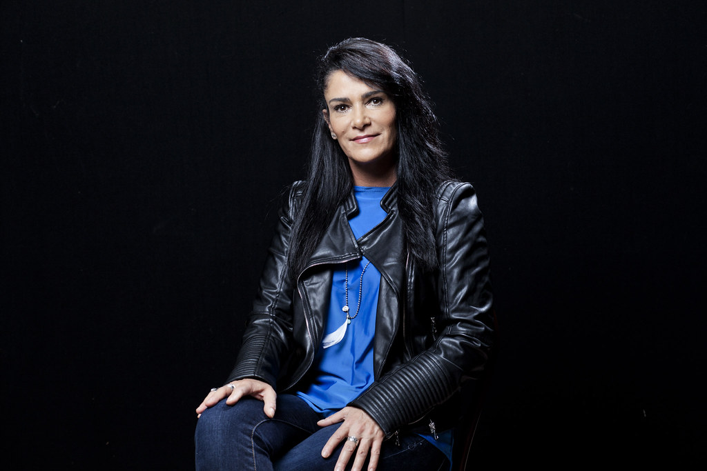 La periodista Lydia Cacho posa de frente con una blusa azul y una chamara de piel